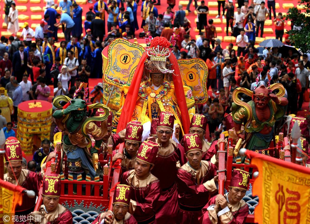People carry the golden sculpture of Mazu back to Mazu's home temple after the sacrificial ceremony on Meizhou Island, Fujian Province, east China, May 28, 2018. /VCG Photo